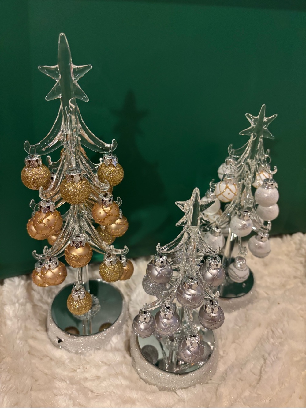 Set of three clear glass lighted Christmas trees with ornaments